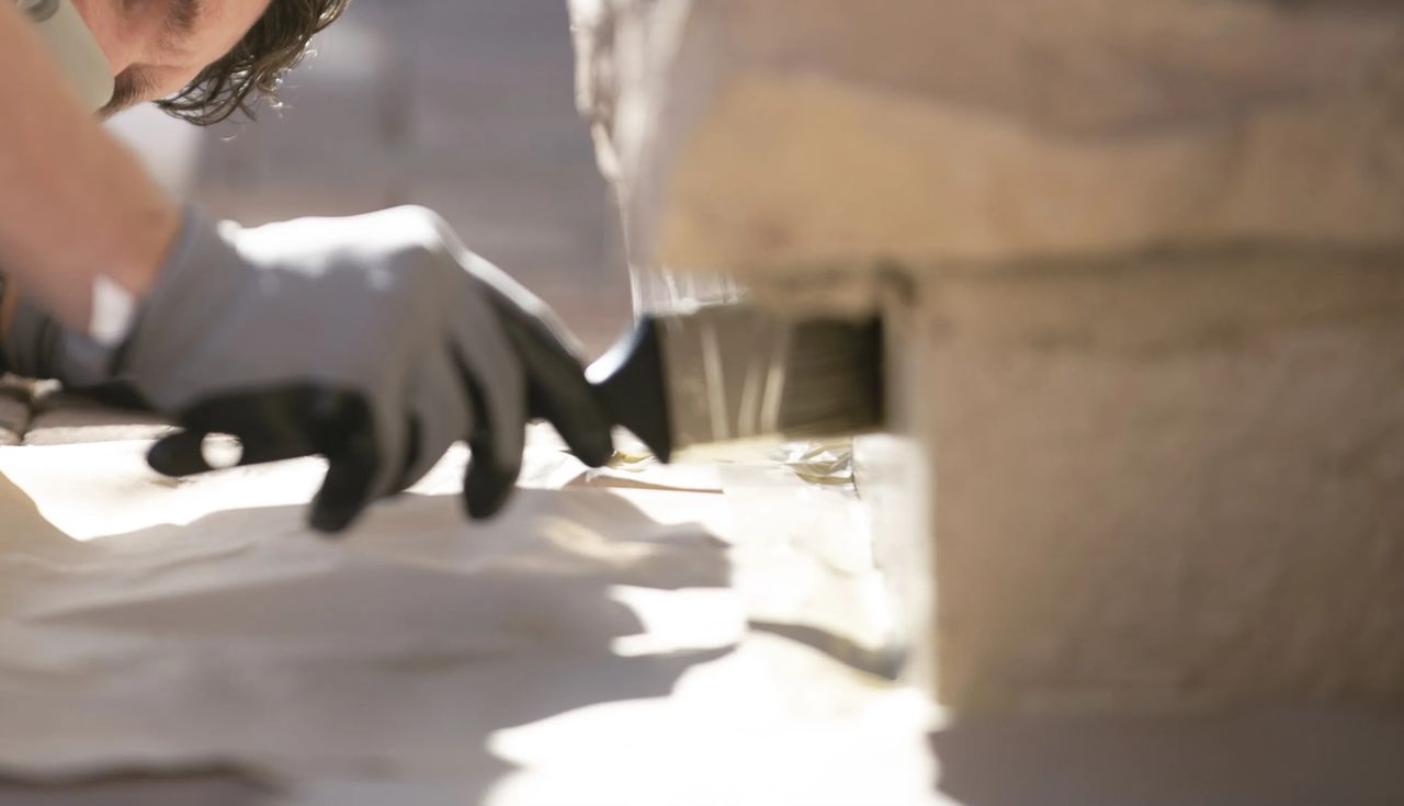 Close-up of Slick Barrier being applied along a foundation